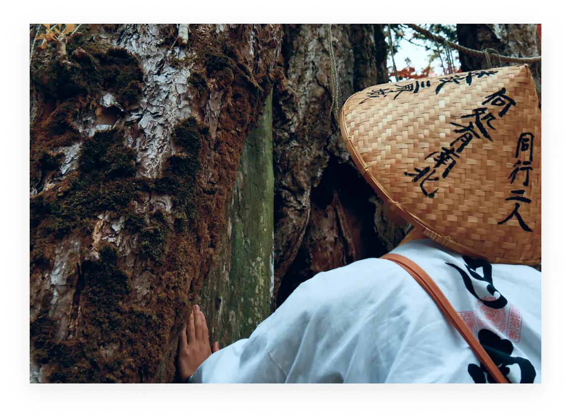 A person wearing a Sugegasa hat and making a pilgrimage