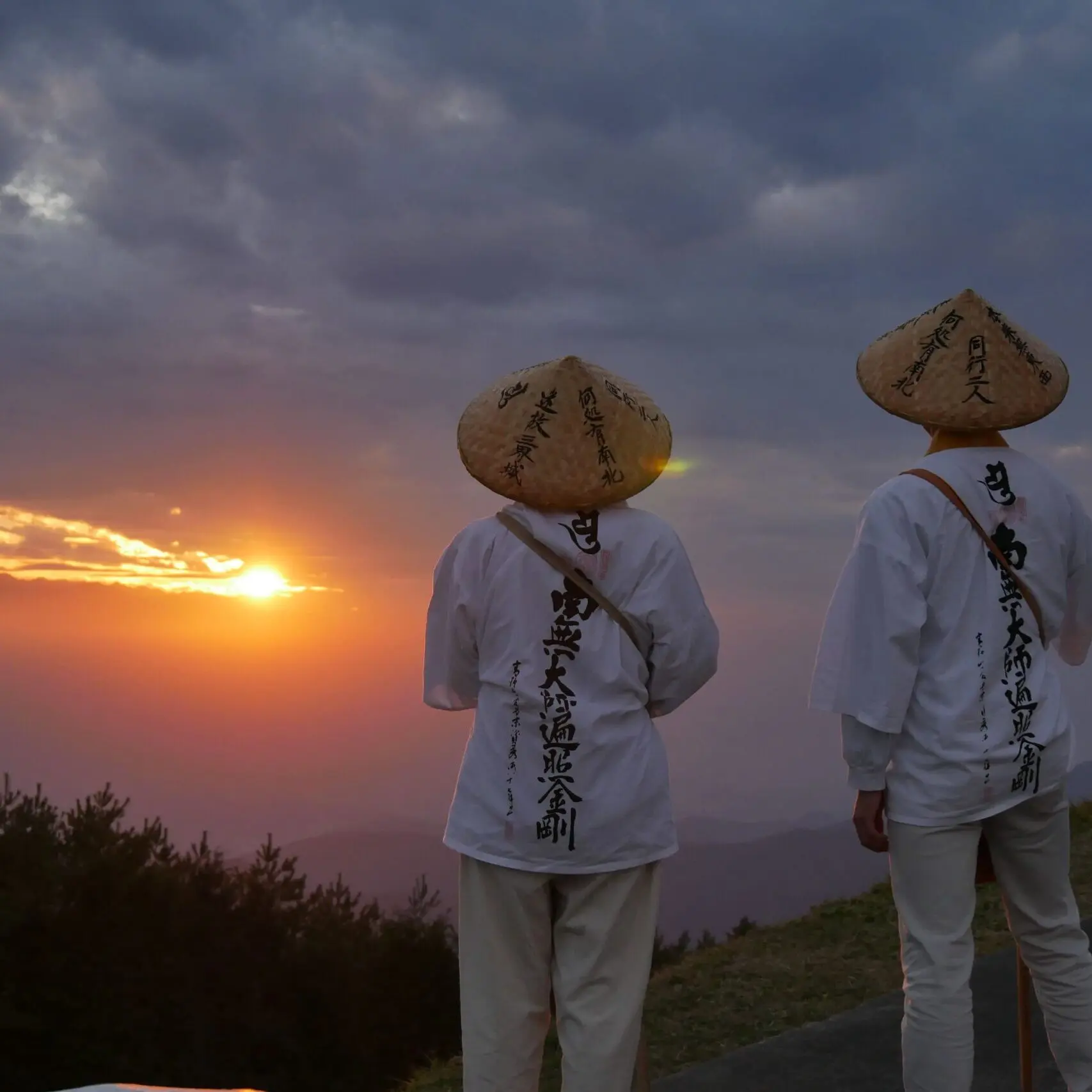 Two people watching the sunset.